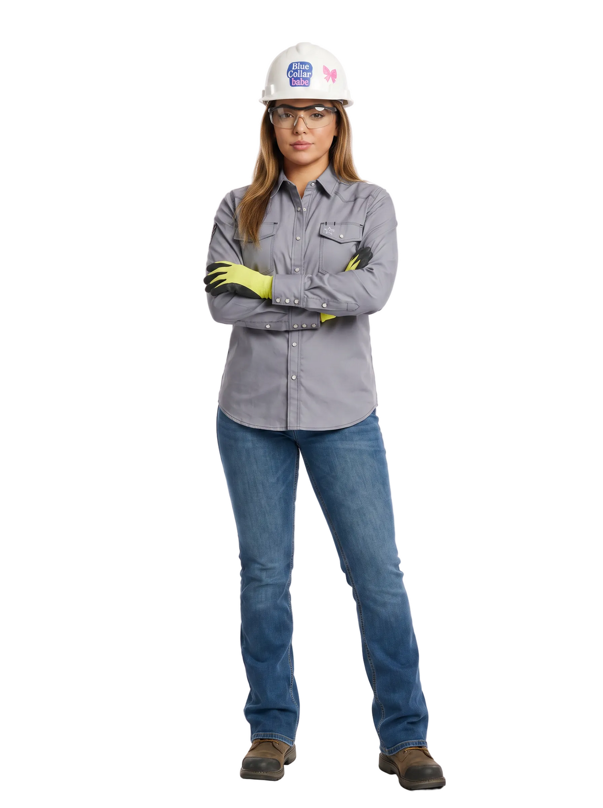 A woman modeling a gray long-sleeve work shirt, blue jeans, a white hard hat, safety glasses, and yellow gloves, standing against a white studio background.