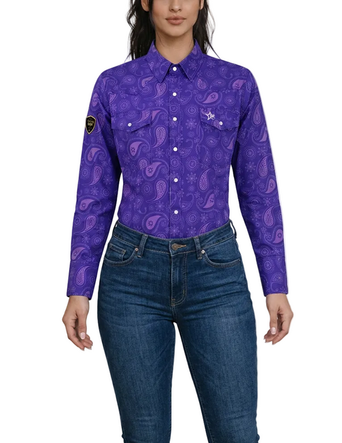 A woman wearing a purple long-sleeve FR button-up shirt with a paisley pattern and blue jeans, shown from the nose down against a plain white background.