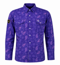 A women's long-sleeve button-up shirt in a vibrant purple color, featuring an all-over paisley pattern in shades of purple and pink. The shirt has two buttoned chest pockets, a pointed collar, and a small black shield patch on the right sleeve 